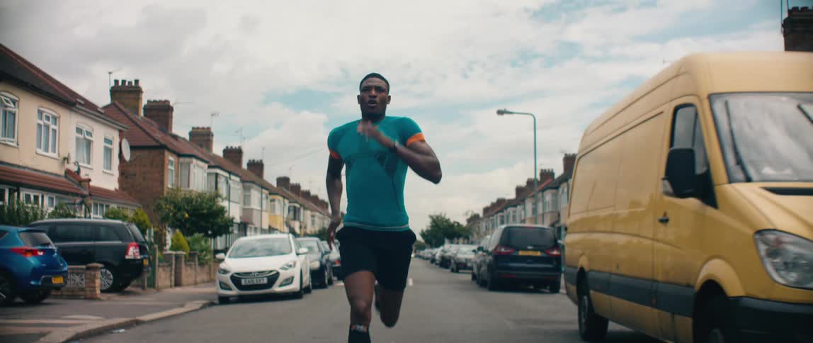 A man runs through the neighborhood