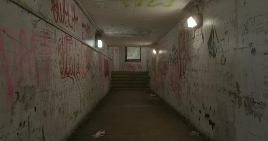 The long tunnel is covered in graffiti