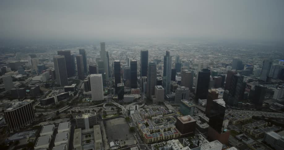 Skyscrapers loom over a metropolis on a foggy day