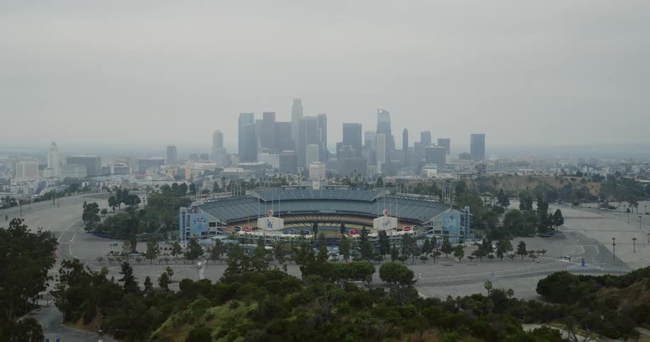 A baseball stadium in metropolis on a foggy day