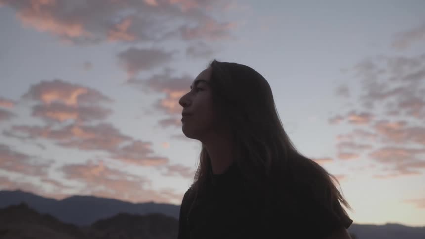 A woman is hiking around the rocks in the desert