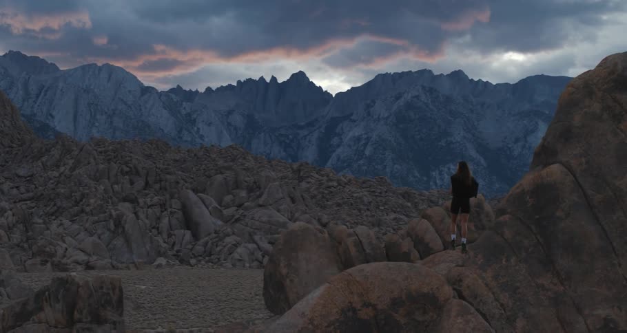 A female adventurer takes in the view in the eastern sierra mountains