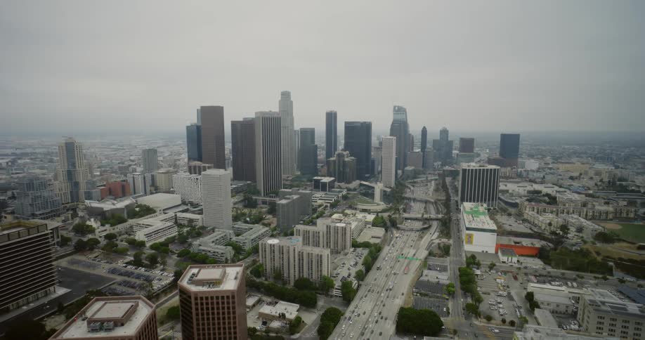 A busy freeway through a metropolis on a foggy day