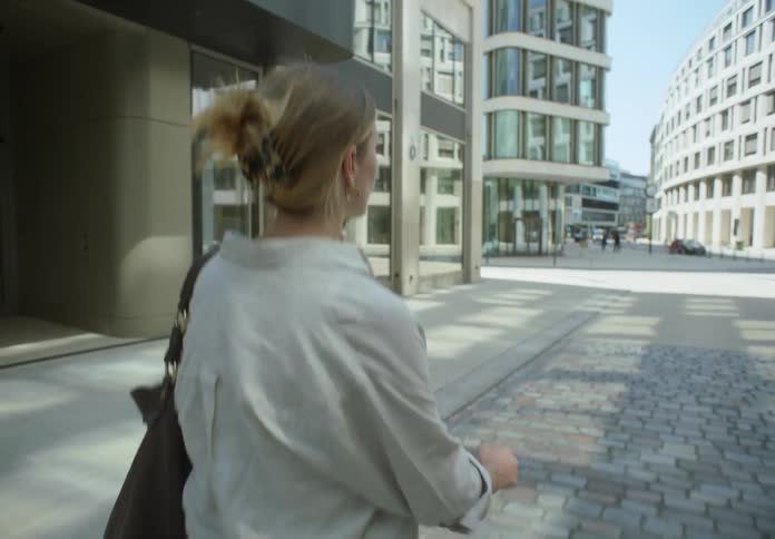 Business woman on her phone turns around
