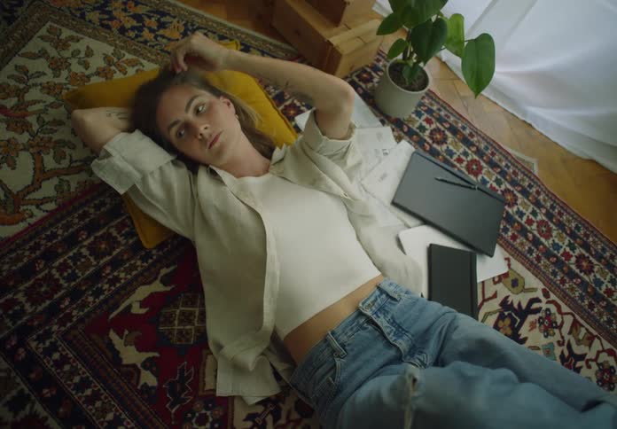 A woman lays on the floor resting