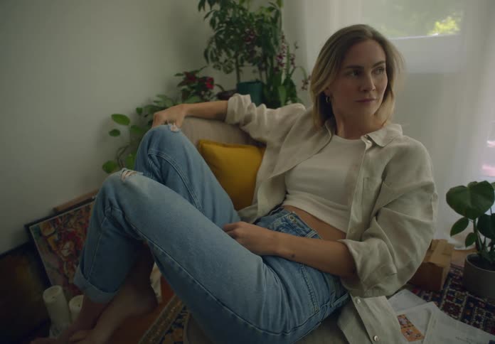 Blonde woman sitting on a chair indoors