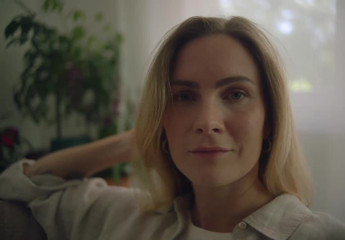 A woman is smiling at home