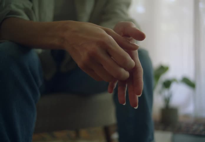 A woman is rubbing her hands together