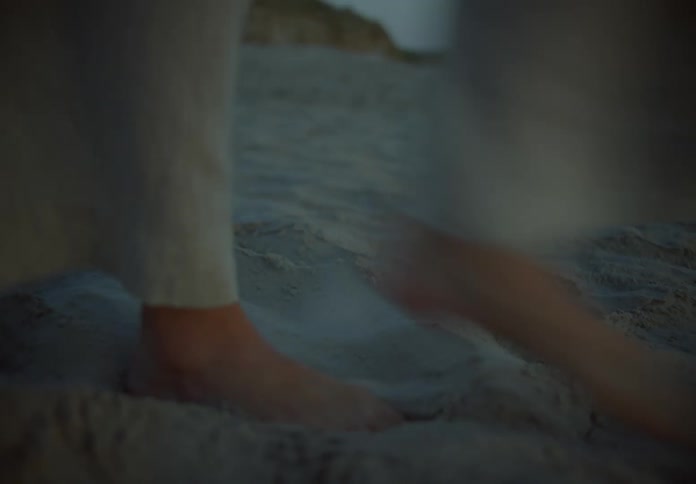 A woman walks in the sand