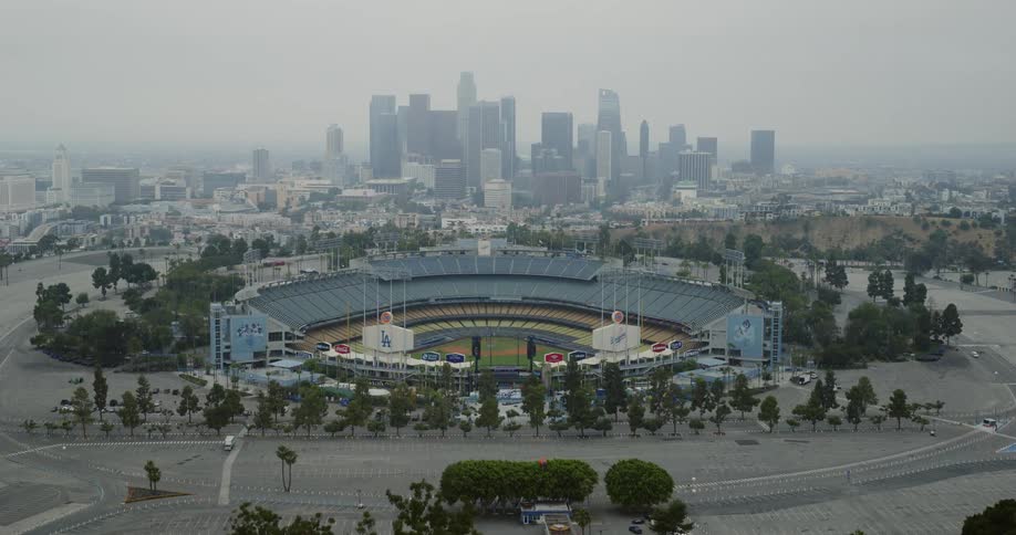 A baseball stadium in a metropolis on a foggy day