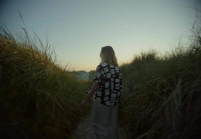 A woman is walking through the path