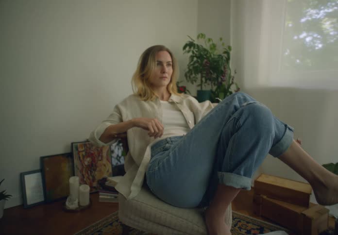 Blonde woman sitting on a chair indoors