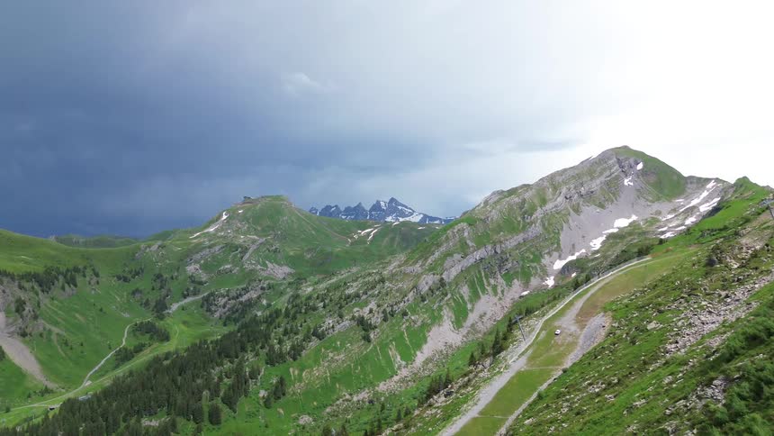 A verdant mountain ridge under a sky half filled with dark clouds