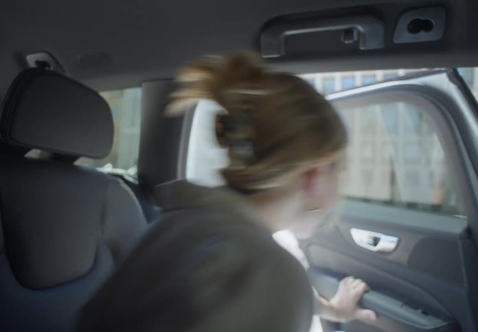 A woman gets out of the car