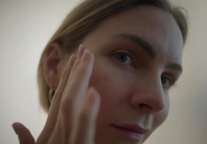 Woman gently massaging her face with her fingers