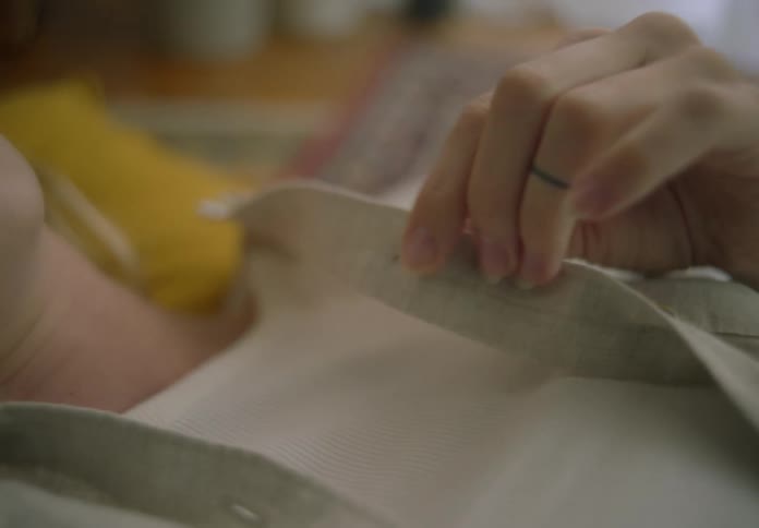Woman feeling the fabric of her shirt