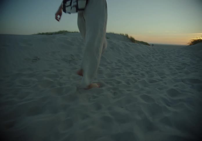 A woman is walking on the beach