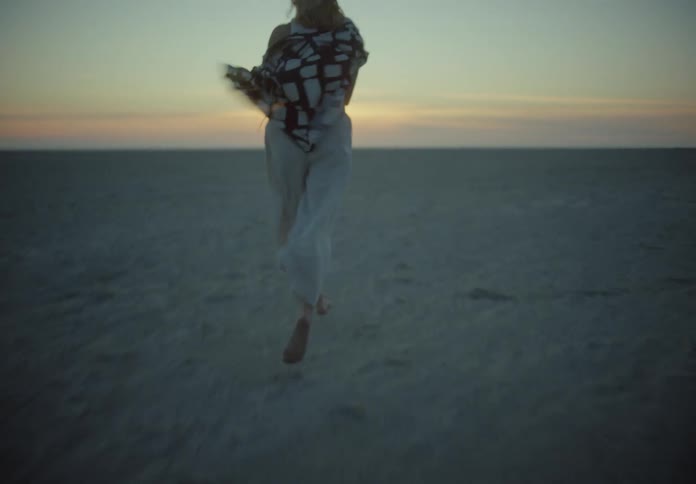 A woman is running on the beach