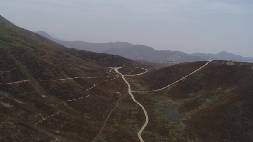Narrow roads wind through rolling hills