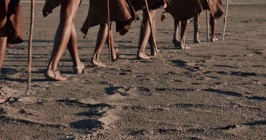 A group of bushmen hike on the field