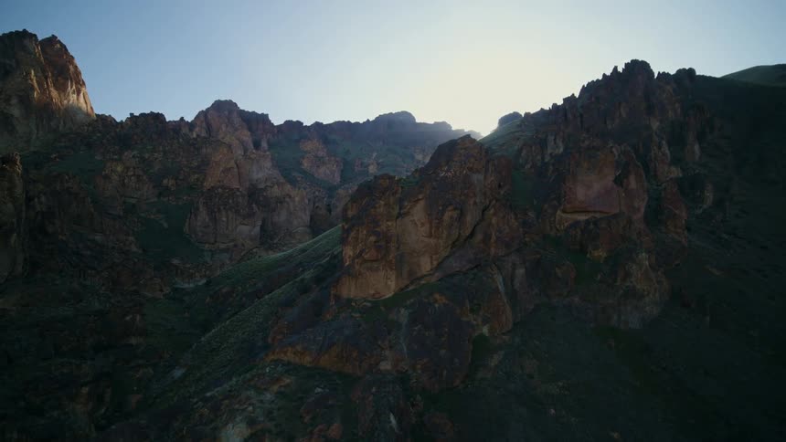 Enormous boulders and towers of red rock form a natural cathedral under the low hanging sun