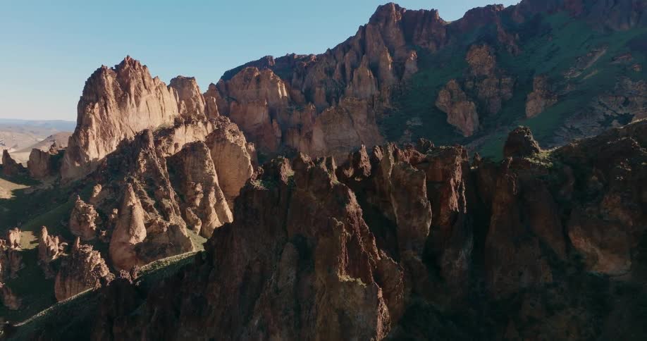 Pullback reveal of a jagged ridgeline amongst rugged mountains