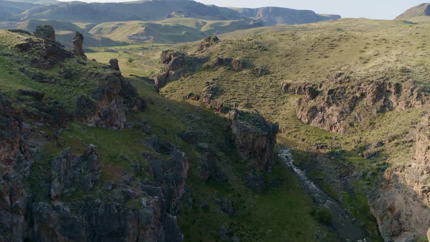 A rushing creek flows through a beautiful rocky canyon