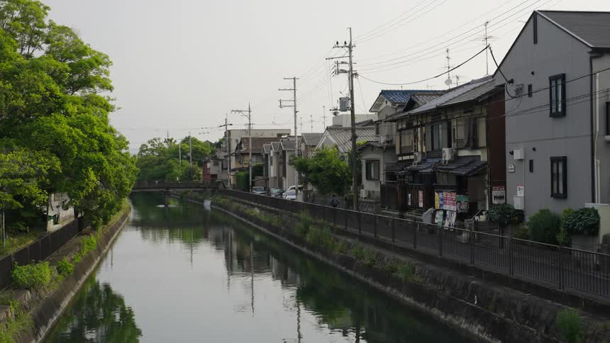 Homes are lined up by a canal in Japan