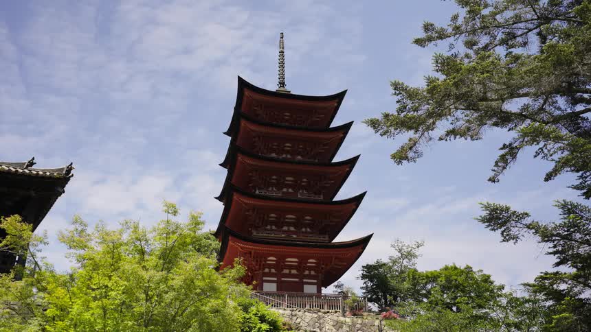 An elaborate and tall building with unique architecture stands out against a clear sky