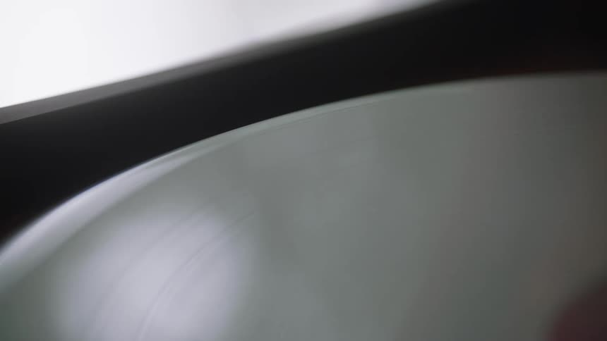 An uneven record can be seen rotating as its spun by a record player