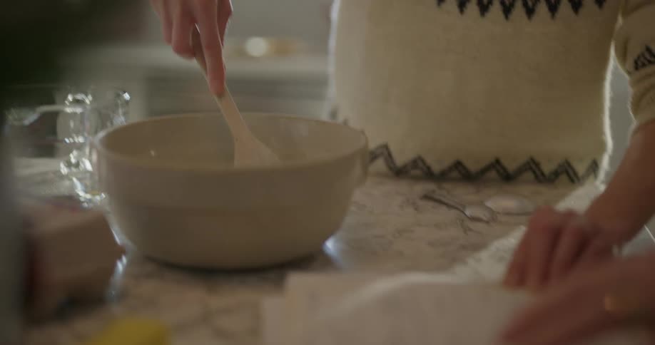 Two people are following a recipe book