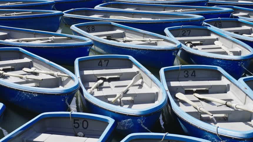 Blue rowboats on the water