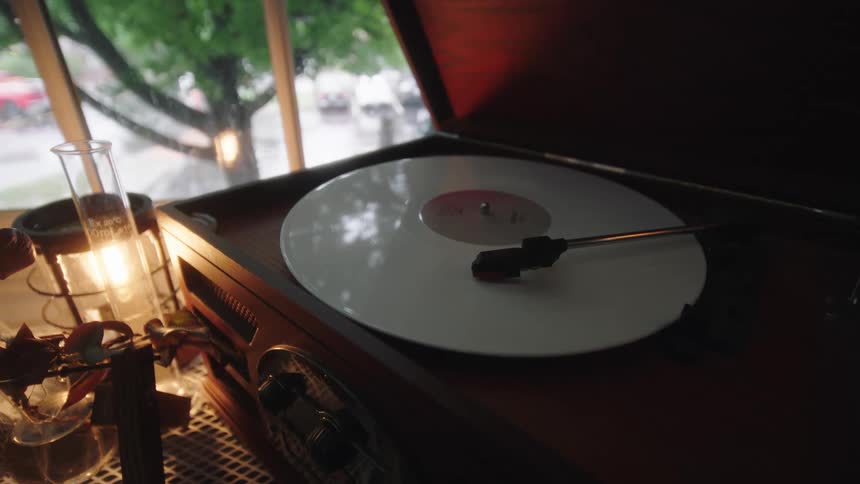A white record spins around on a vintage style record player