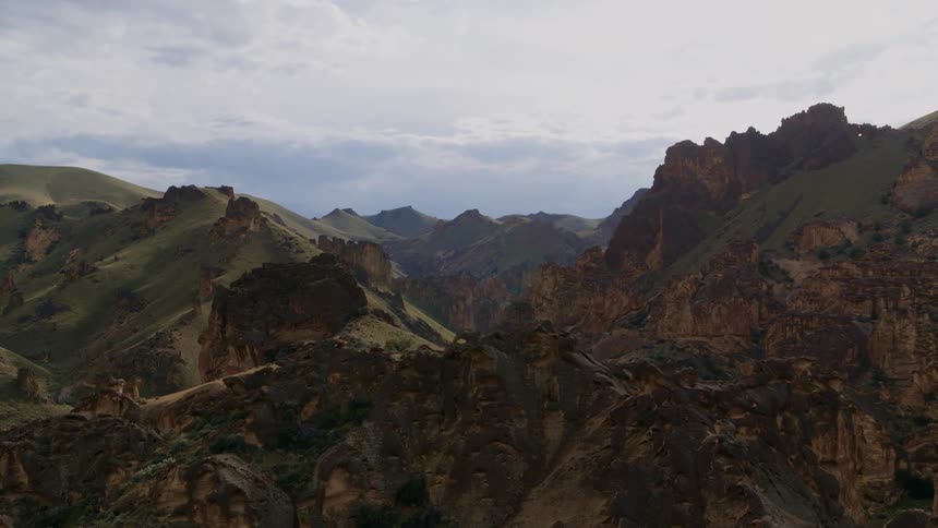 Subtle orbit around a completely wild landscape of mahogany colored cliffs and jagged rock spires