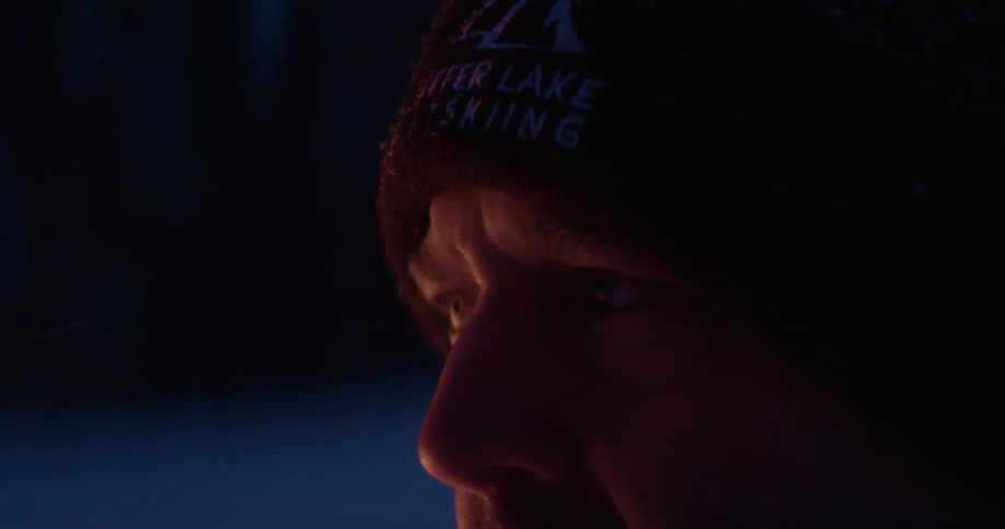 Close up of mans face wearing brown cold weather cap