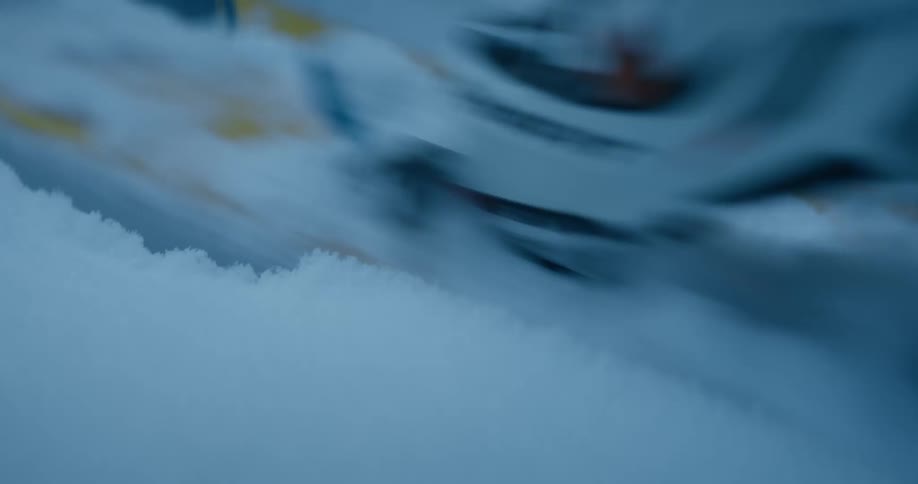 A person wearing snow ski slowly walks across the snow
