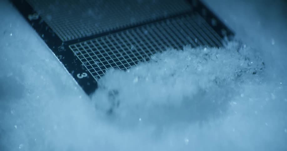 A person scoops up a small amount of snow using a metal tool