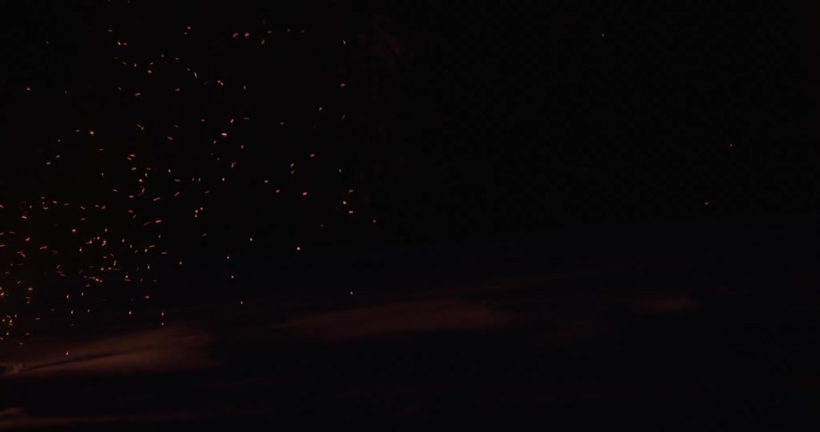 Flames from a bonfire flying in the night