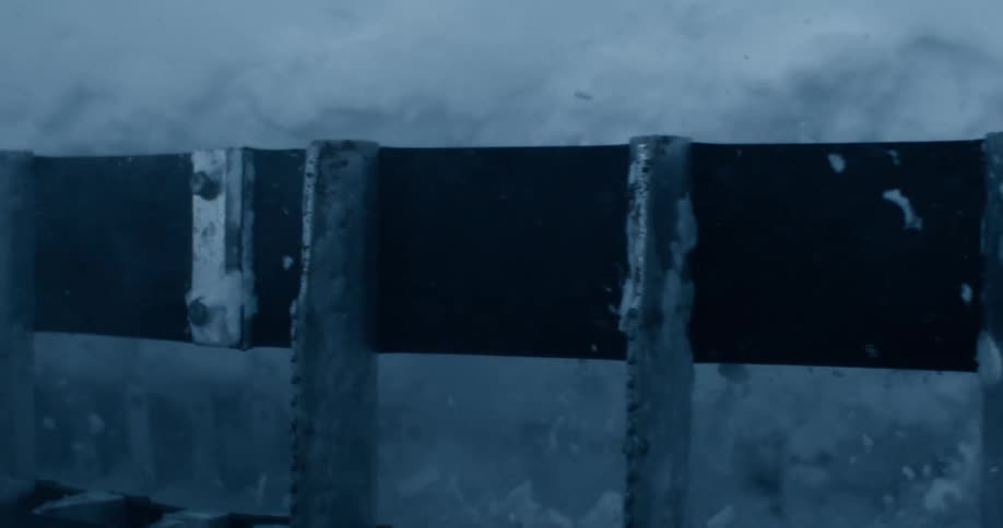 An arctic bridge constructed from a combination of wood and steel with its surface completely covered in ice