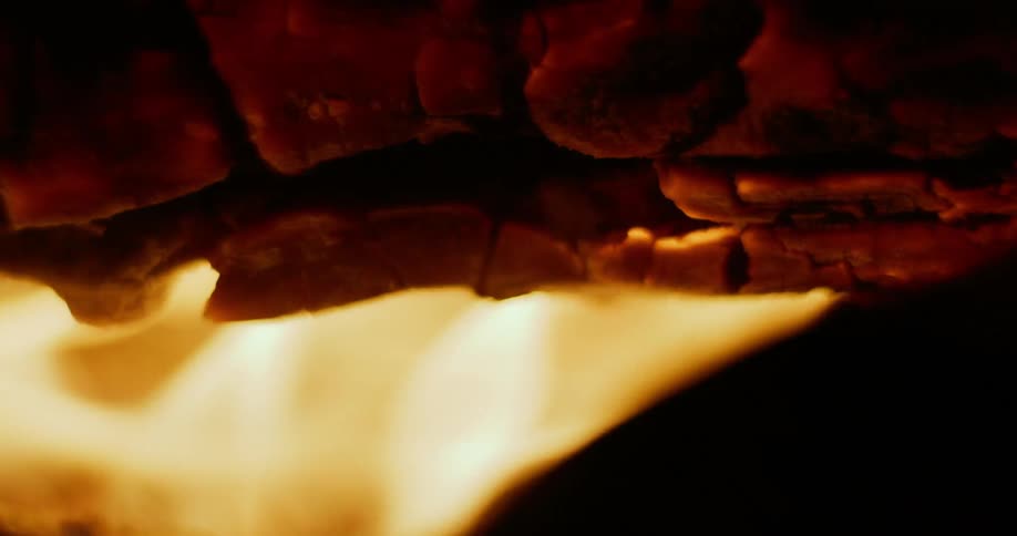 Close up view of a wood log burning with fire