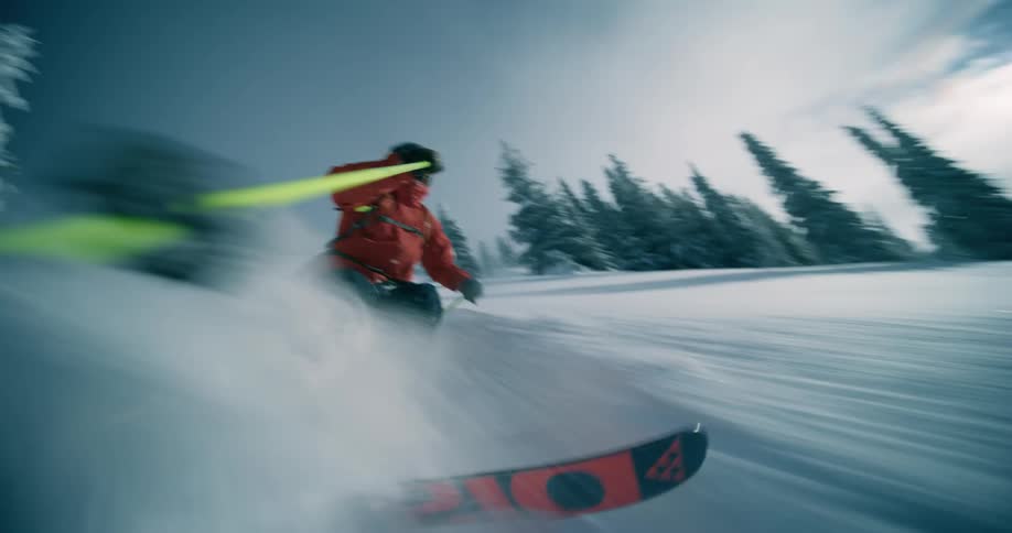 Man snow skiing at high speed on a mountain