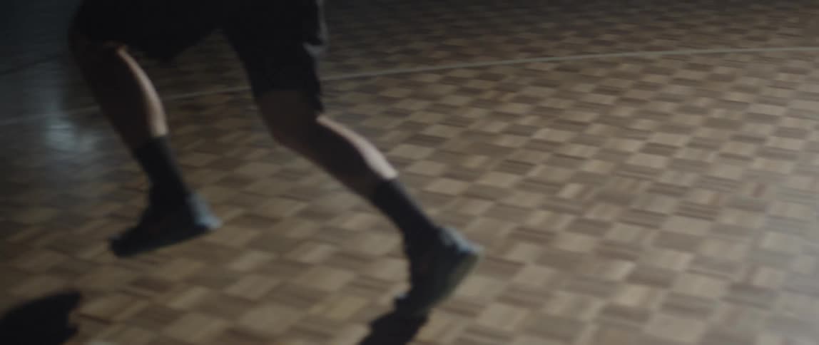 A man is running in a long dark hall
