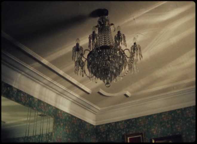 The light reflects off the chandelier