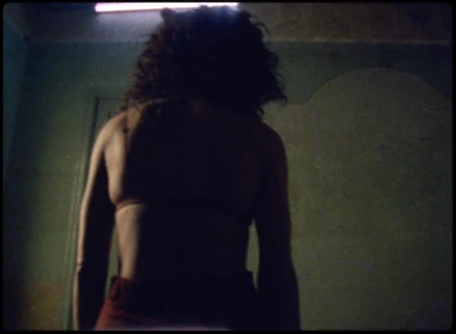 A woman walks towards the door