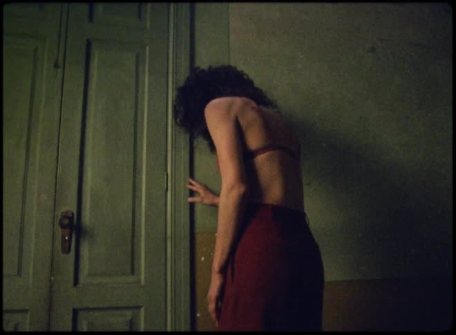 A woman touches the door and falls backwards