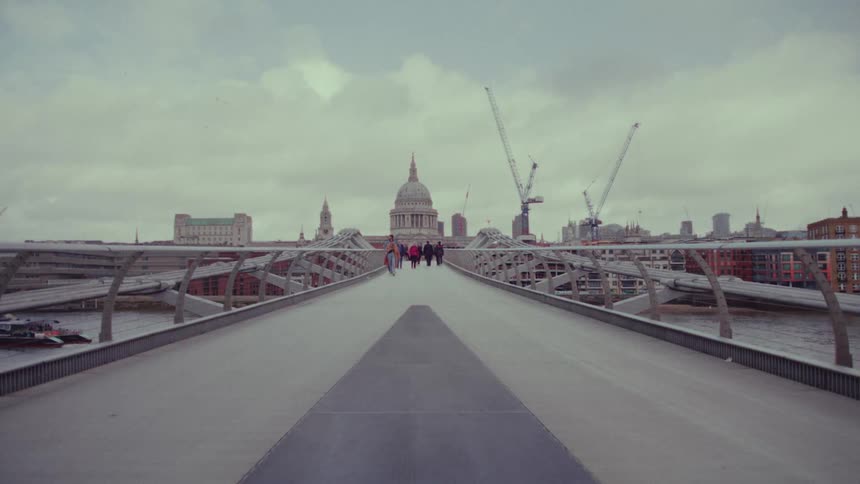 Pedestrians walk across the bridge