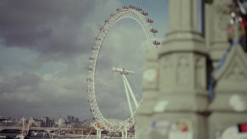 In a metropolitan area a large ferris wheel remains motionless