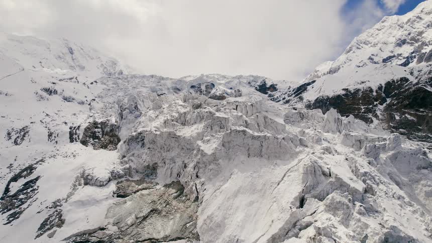 Aerial view of a glacier and white snow in the mountains