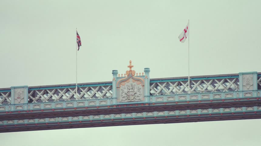 Overhead walkway with a royal monument and two flag on each side