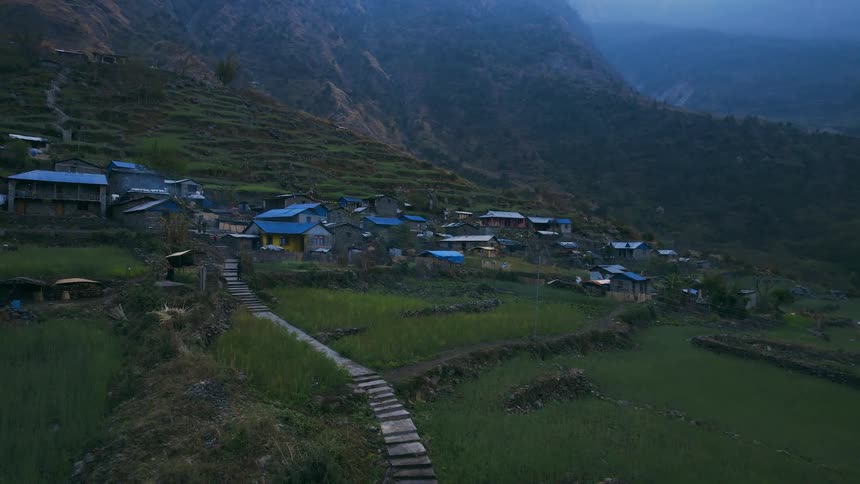 A small village surrounded by mountain with green vegetation